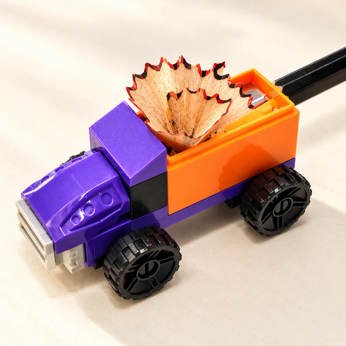 A pencil being sharpened into the truck bed, shavings collecting inside