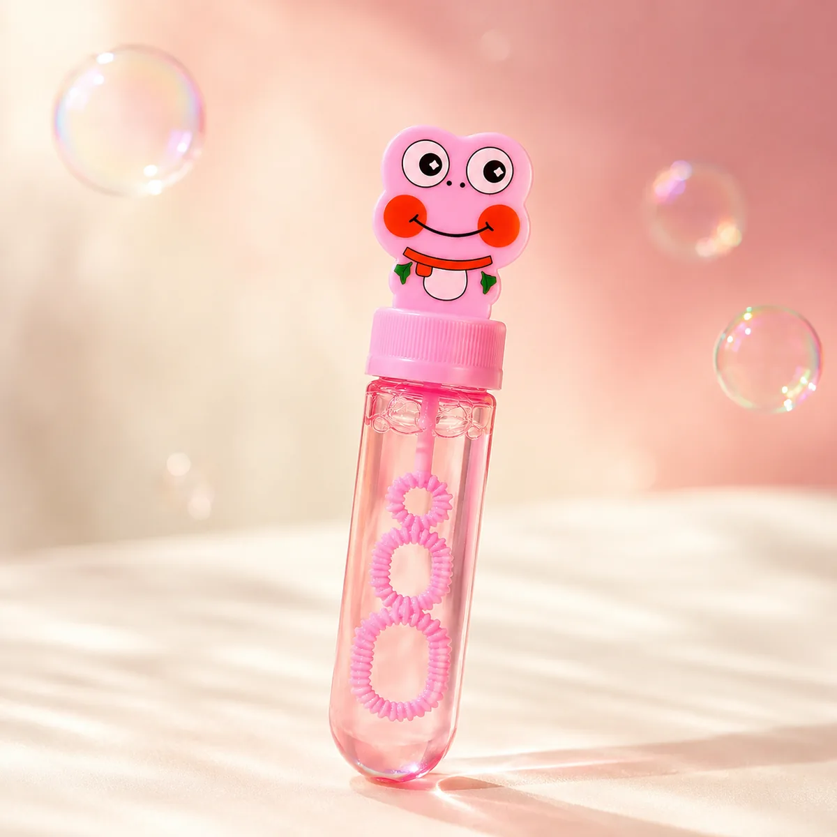 Pink frog bubble wand close-up with floating bubbles