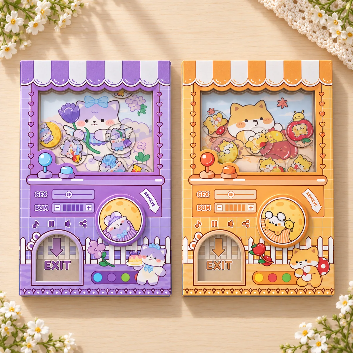 The purple kitty and orange puppy notebooks lying flat, showing the same capsule-machine cover in two more colourways