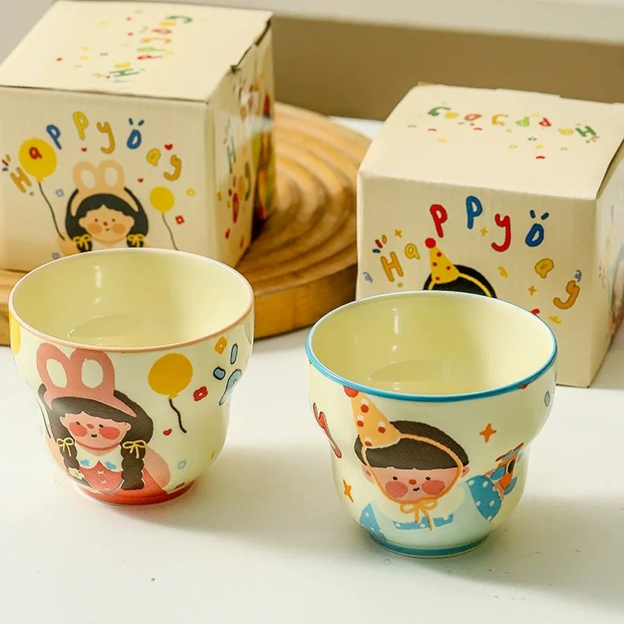 Two mugs beside their printed gift boxes
