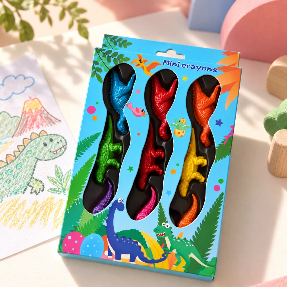 The boxed set beside a child's crayon drawing of a dinosaur and a volcano