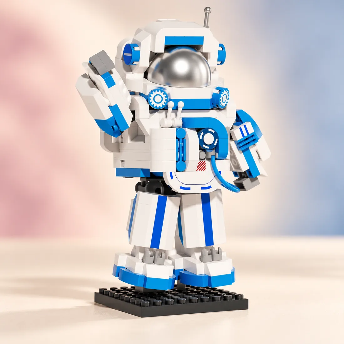 The blue astronaut standing with a hand lifted