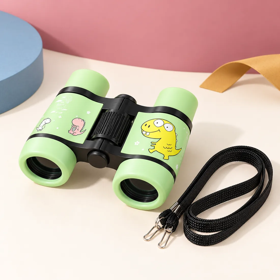 The green pair with its neck strap coiled beside it