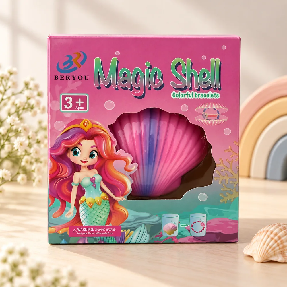 The printed box front, marked ages 3+ with a diagram showing the shell going into water