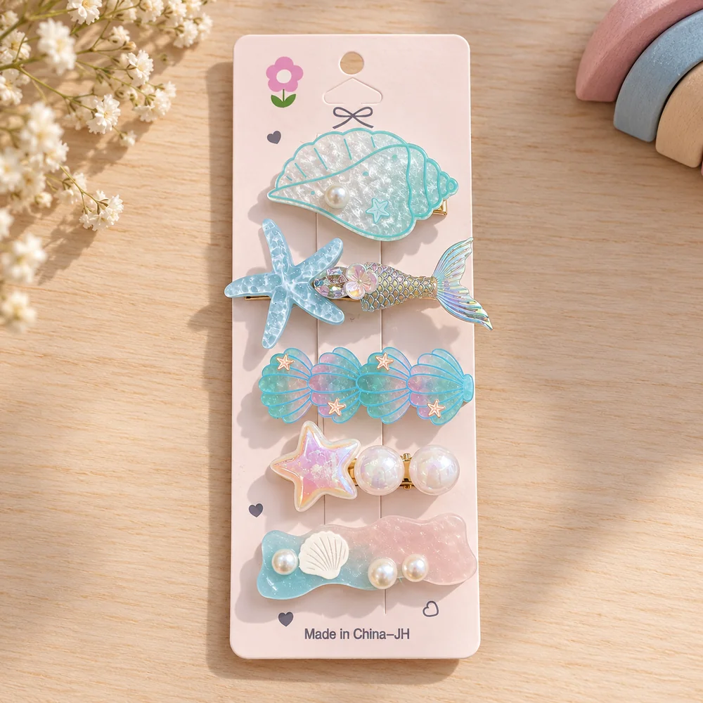 The mint card — a conch shell, a starfish paired with a mermaid tail, four linked shells, a star with pearls and a wavy pastel bar